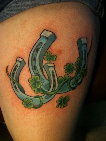 Two horseshoes and clover for luck tattoo