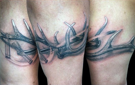 Typical 3D style colored leg tattoo of deer horns with bullets