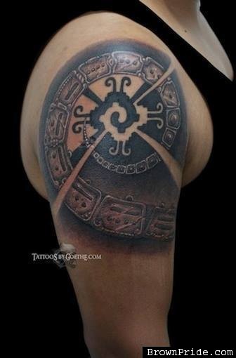 Typical black and white shoulder tattoo of antic symbols