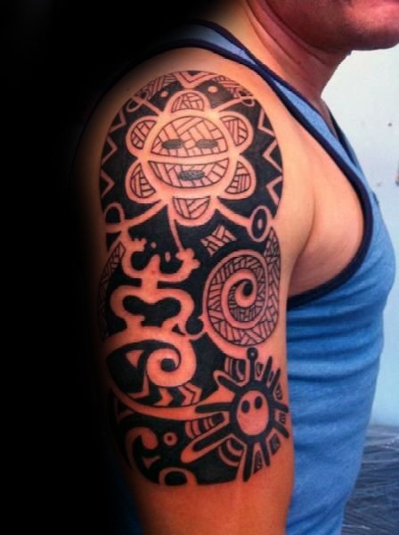 Typical black and white shoulder tattoo of various ornaments