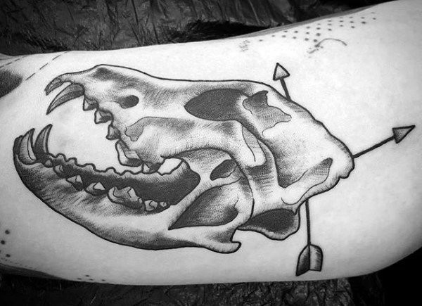 Typical black ink animal skull tattoo with arrows
