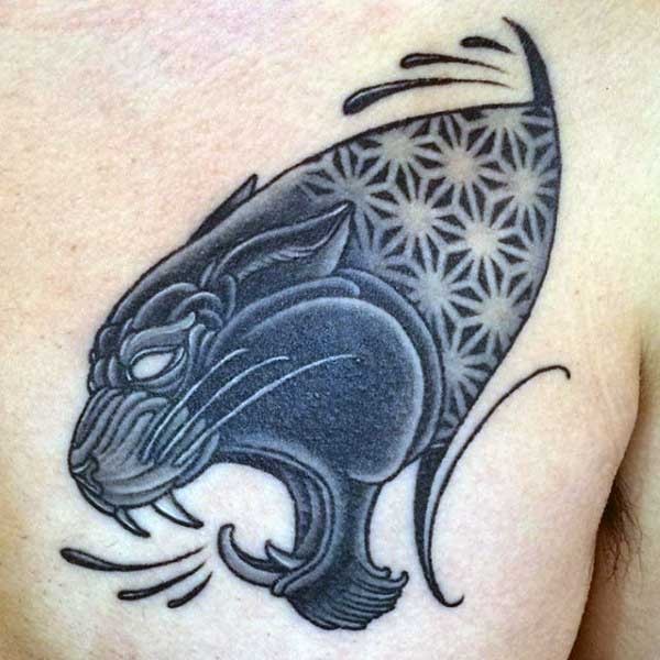 Typical black ink chest tattoo of black panther