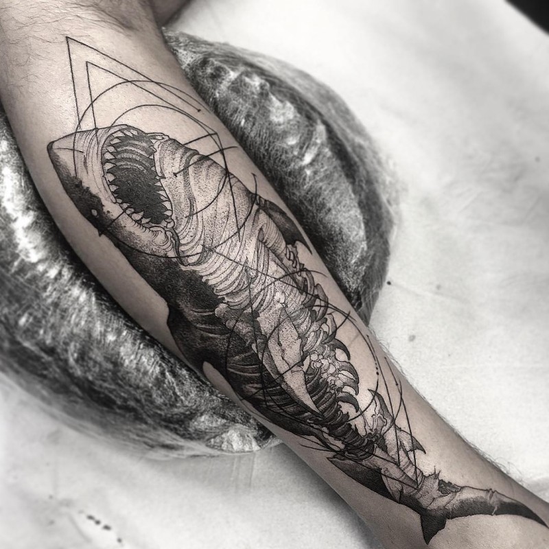 Typical black ink engraving style leg tattoo of zombie shark