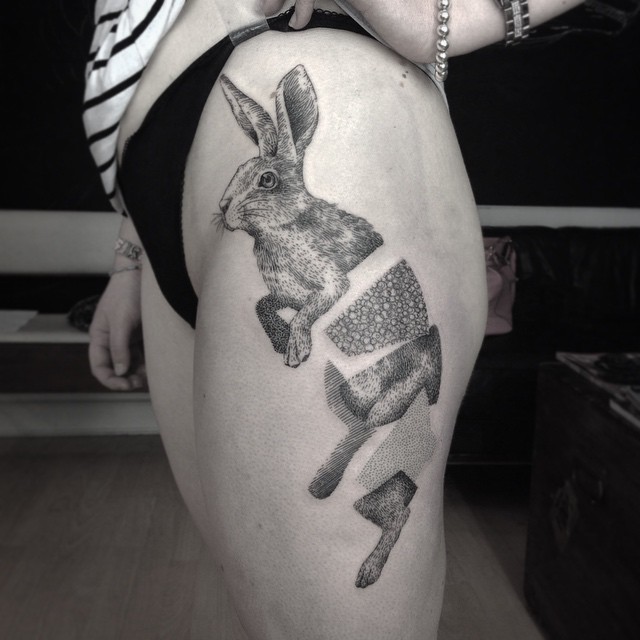 Typical black ink engraving style thigh tattoo fo divided rabbit