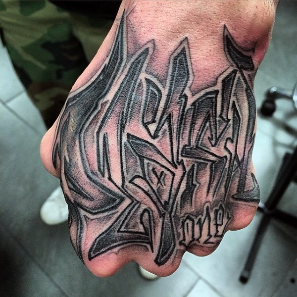 Typical black ink fist tattoo of graffiti style lettering