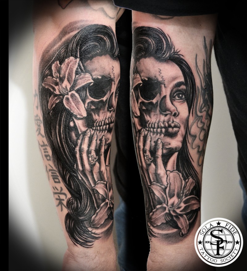 Typical black ink forearm tattoo of half skull half woman face tattoo with flower