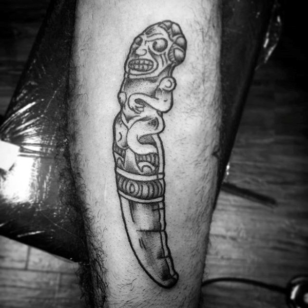 Typical black ink leg tattoo of ancient stone statue