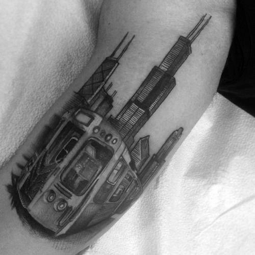 Typical black ink modern city train tattoo on arm