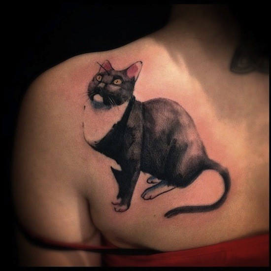 Typical black ink scapular tattoo of cute cat