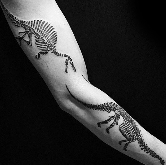 Typical black ink sleeve tattoo of various dinosaurs skeletons