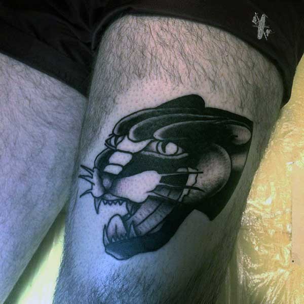Typical black ink thigh tattoo of black panther