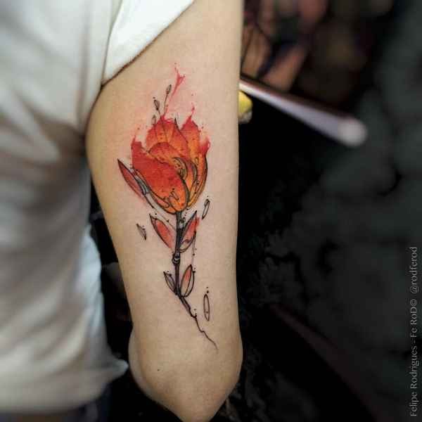 Typical colored arm tattoo of burning flower