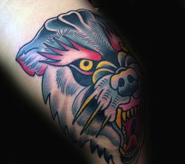 Typical colored arm tattoo of colored wolf