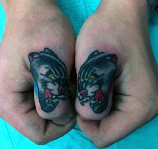 Typical colored fingers tattoo of black panthers