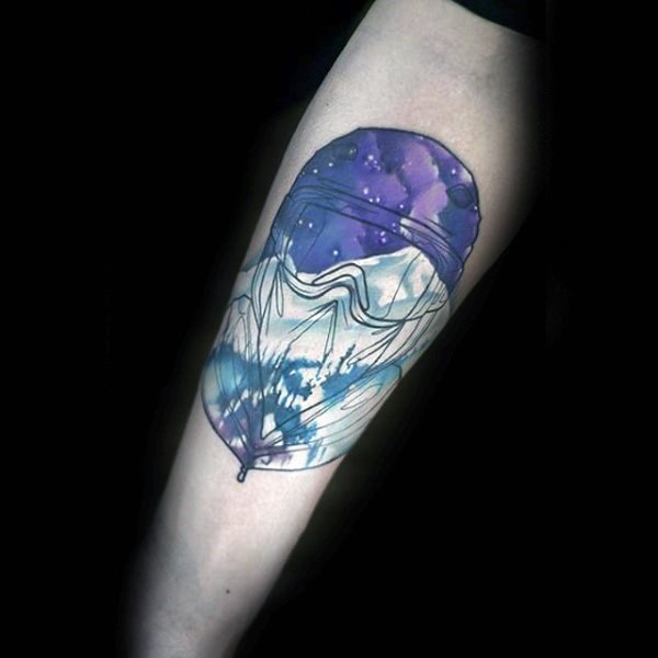 Typical colored forearm tattoo of balloon with mountains
