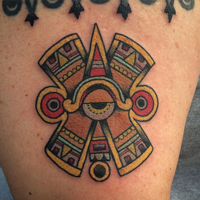 Typical colored shoulder tattoo of ancient mystic wall symbol