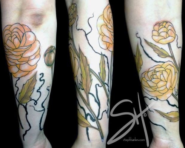 Typical designed and colored forearm tattoo of flowers