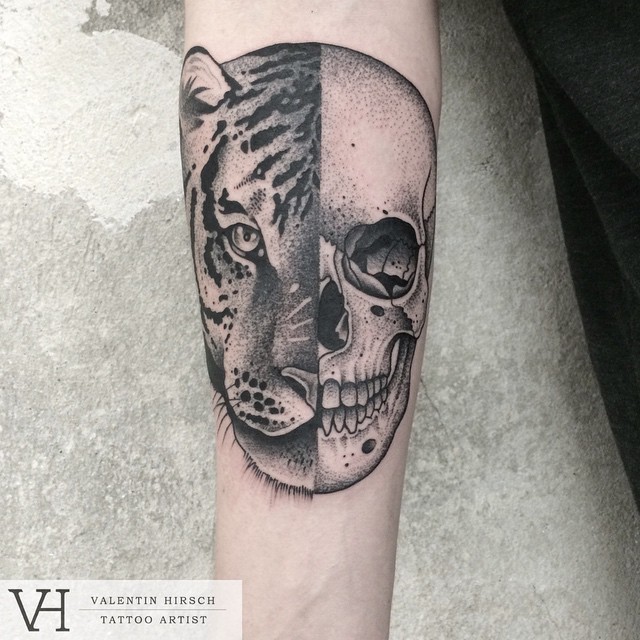 Typical designed by Valentin Hirsch forearm tattoo of Leopard and human skull
