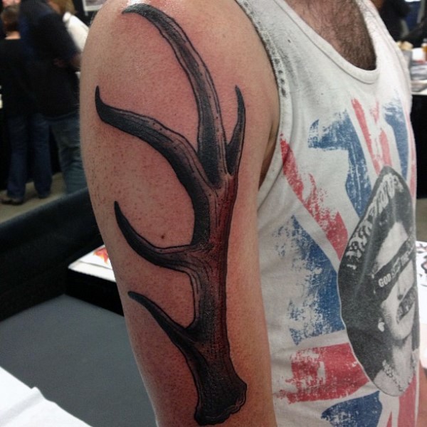 Typical engraving style shoulder tattoo of deer horn