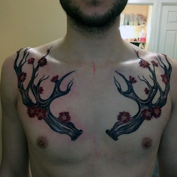 Typical funny looking colored chest tattoo of blooming deer horns