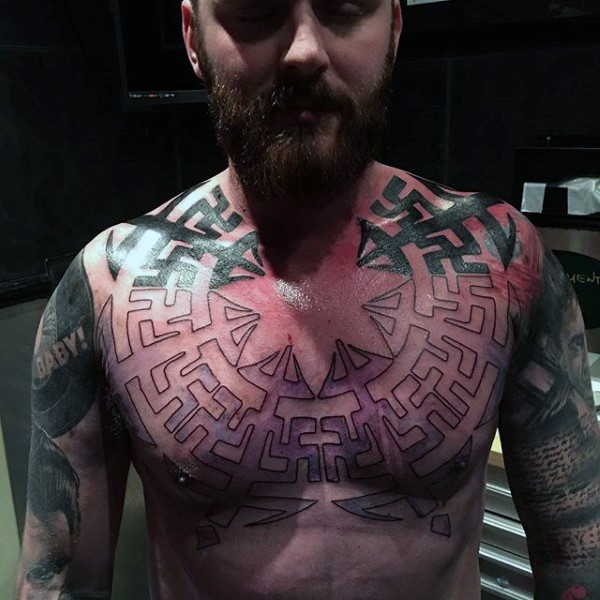 Typical half colored geometrical style chest tattoo