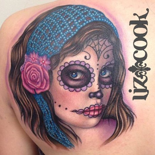 Typical Mexican traditional style colored scapular tattoo of woman face