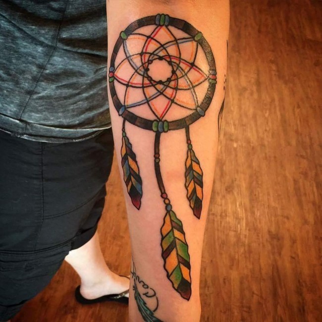 Typical multicolored forearm tattoo of dream catcher