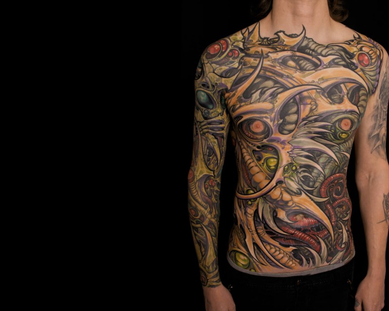 Typical multicolored sleeve, chest and belly tattoo of alien bones