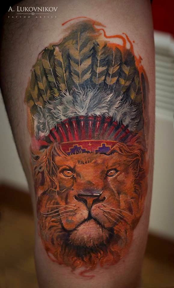 Typical multicolored thigh tattoo of lion with Indian helmet