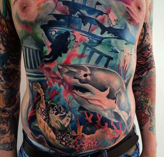 Typical multicolored underwater life with sharks and turtle tattoo on chest and belly