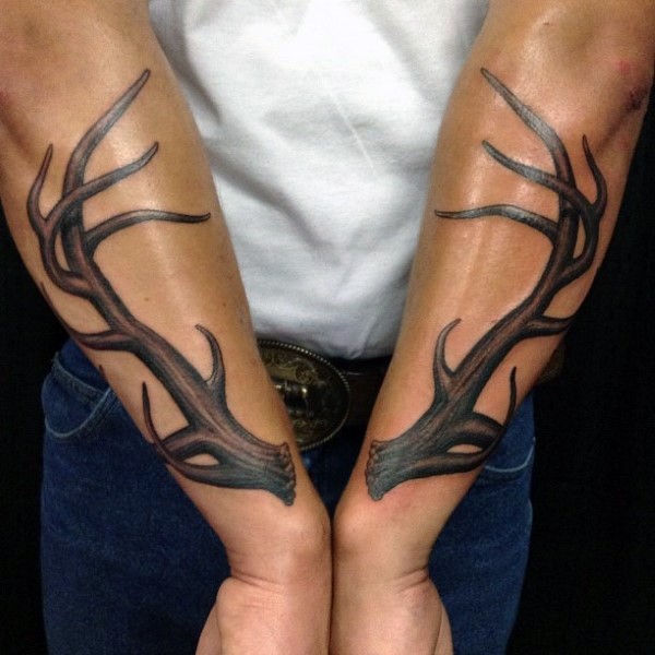 Typical realistic looking forearm tattoo of deer horns
