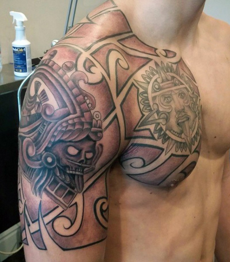 Typical tribal tattoo on chest and shoulder with various sculptures