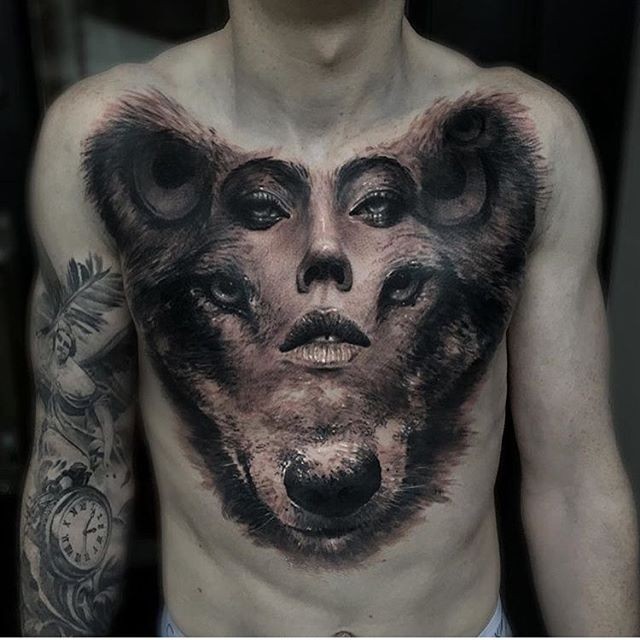 Unbelievable black ink lion head with human face tattoo on chest