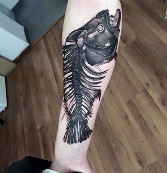Unbelievable black ink realism style fish skeleton tattoo on forearm