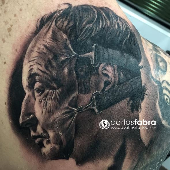 Unbelievable black ink tattoo of man with human skin mask