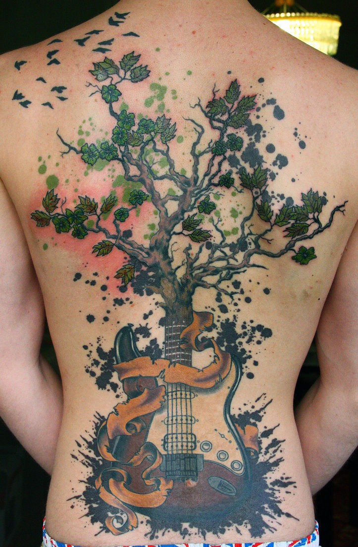 Unbelievable colored whole back tattoo of half tree half guitar