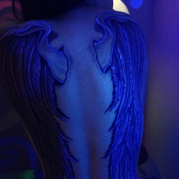 Unbelievable glowing ink painted massive wings tattoo on whole back