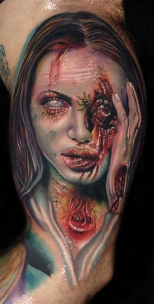 Unbelievable looking colored horror style very detailed biceps tattoo of zombie woman face