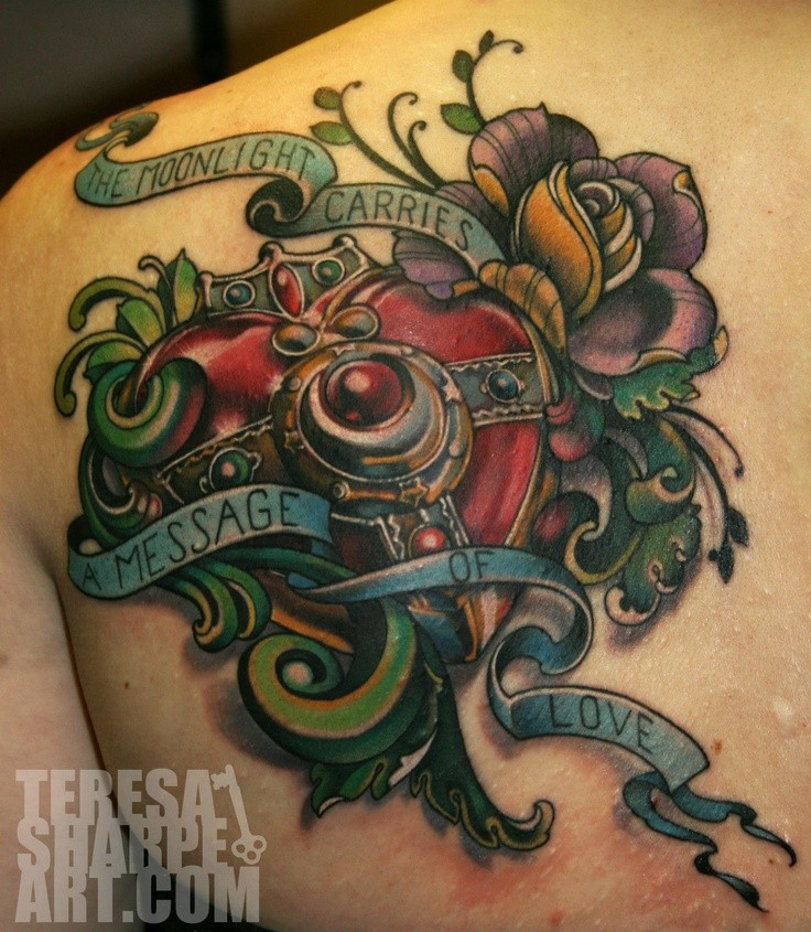 Unbelievable painted colored mechanical heart tattoo on back with flowers and lettering