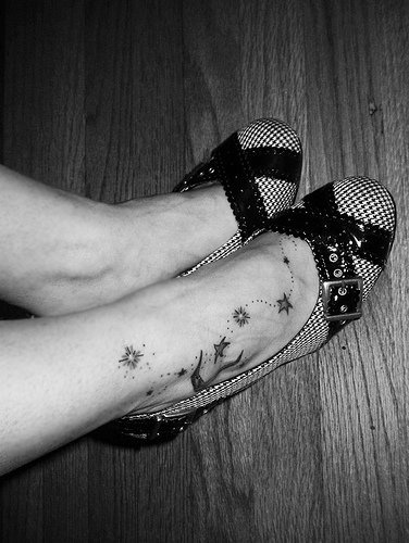 Uncolored moon and stars ankle tattoo
