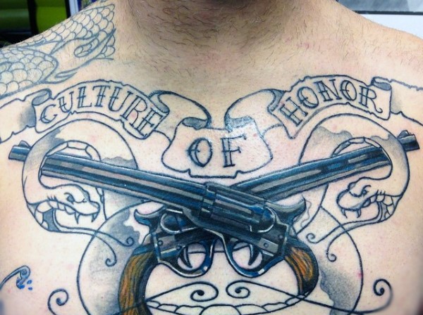 Unfinished half colored illustrative style chest tattoo of crossed pistols and lettering