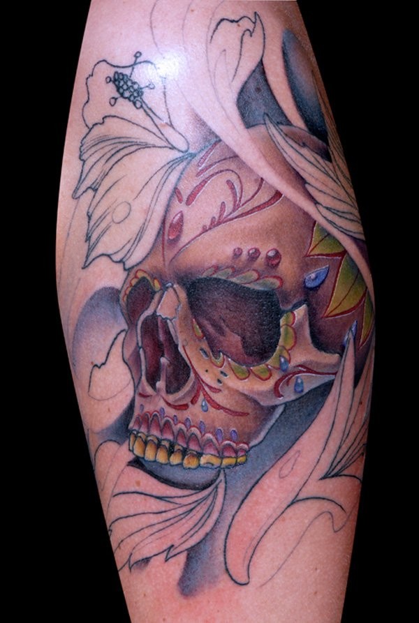 Unfinished half colored Mexican traditional style human skull tattoo combined with flowers