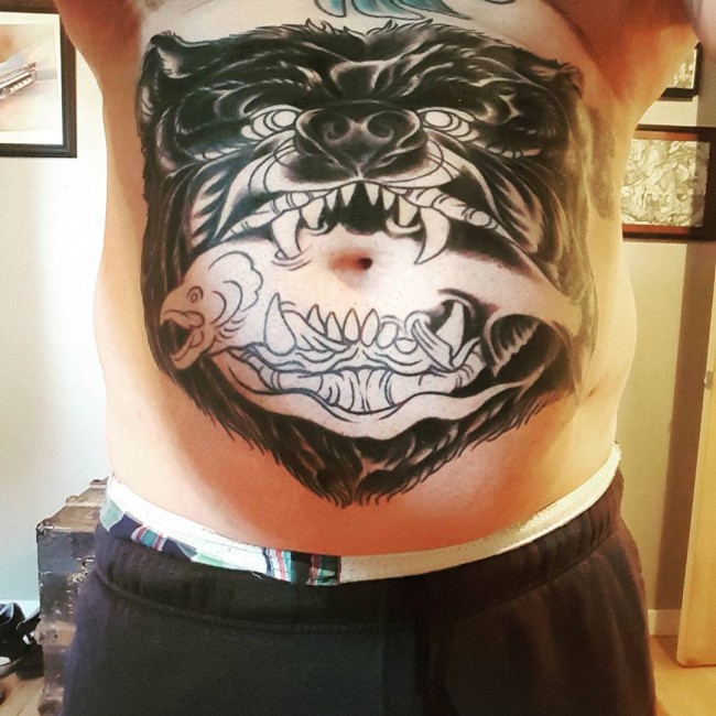 Unfinished illustrative style belly tattoo of bear with fish