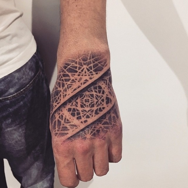 Unique black and white rail road like tattoo on hand with ornaments
