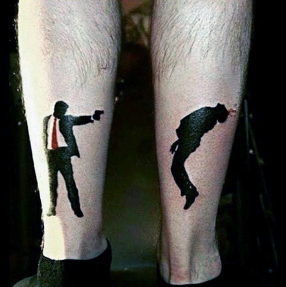 Unique colored legs tattoo of man shooting another one