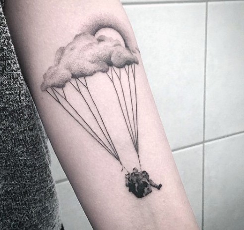 Unique designed black and white cloud shaped man with parachute tattoo on arm