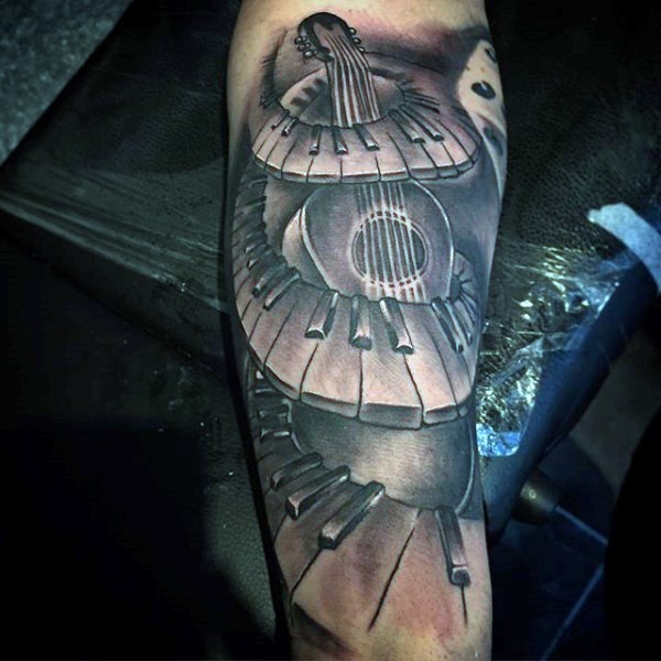 Unique designed black and white guitar with piano keys tattoo on arm