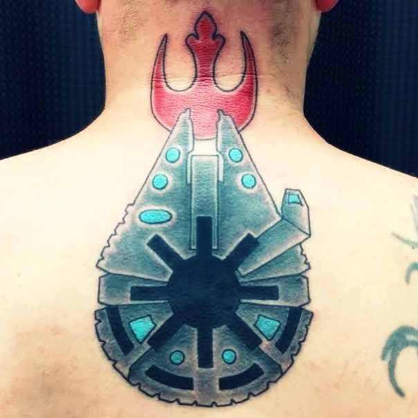 Unique designed colorful millennium falcon shaped Empire emblem tattoo on upper back with Rebel emblem