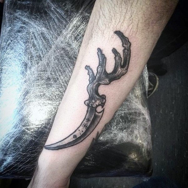 Unique designed engraving style mystical knife tattoo on arm with deers horn