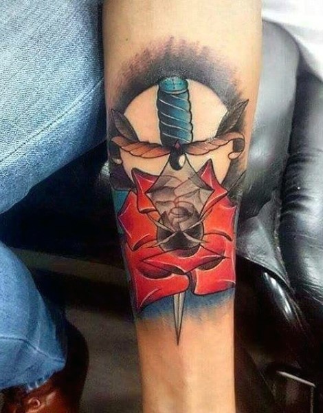 Unique painted and colored dagger in flower tattoo on arm